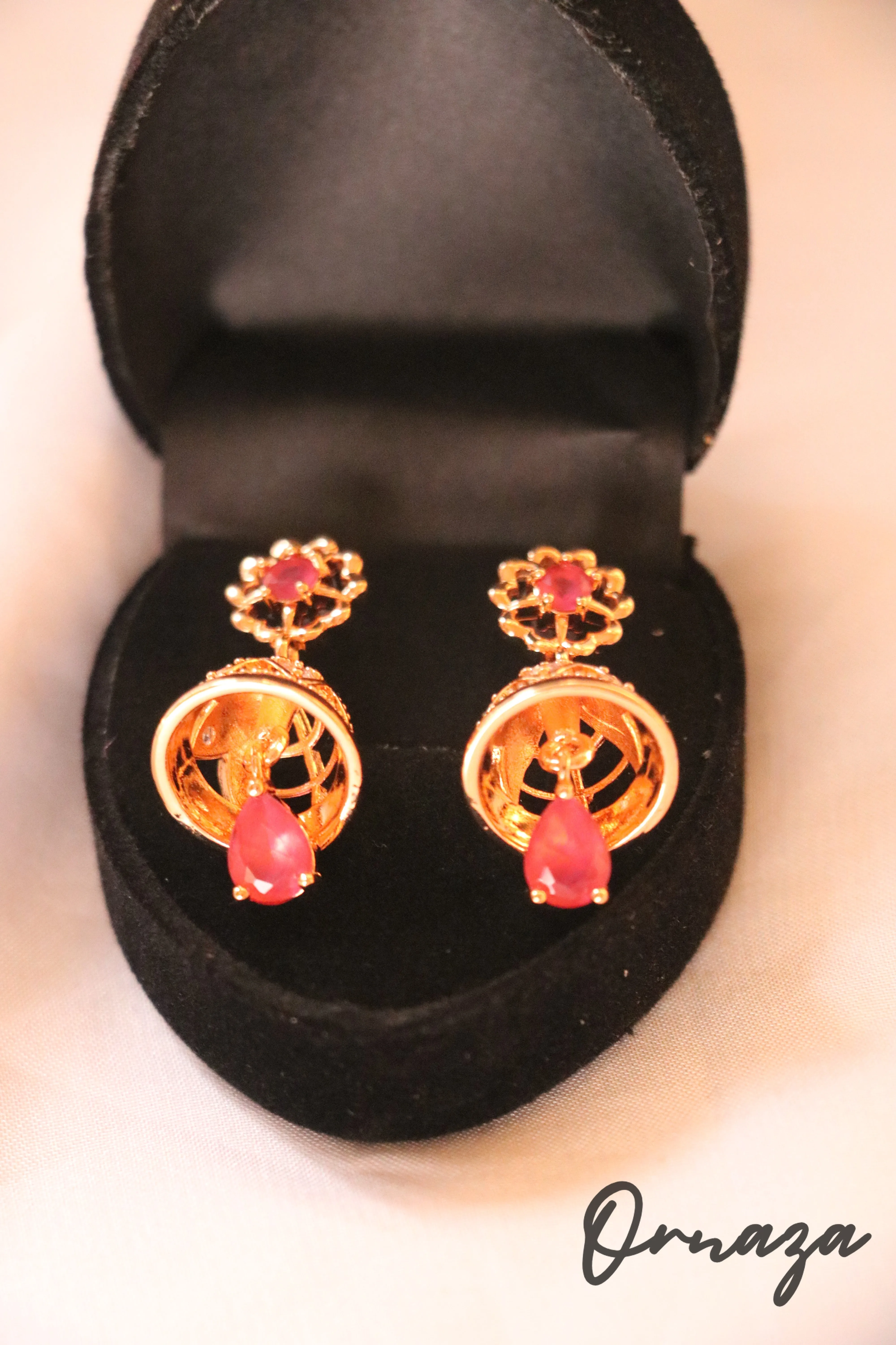Gold-Plated Floral Jhumka Earrings with Ruby Red Accents – A Blend of Tradition and Elegance